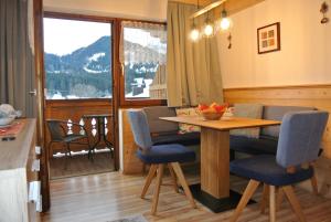 a kitchen and dining room with a table and chairs at Haus Kraft in Sankt Martin am Tennengebirge