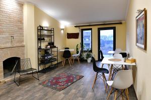 a living room with a fireplace and a table and chairs at woolway studios in Argavand