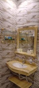 a bathroom with a sink and a mirror at فندق هلا اثنين in Arar