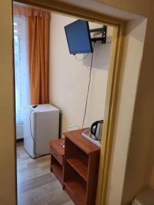 a room with a sink and a television on the wall at O.W.S. Strzecha in Duszniki Zdrój