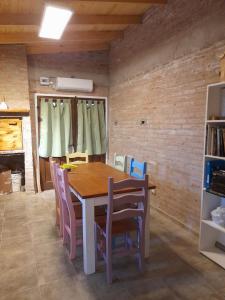 a dining room with a wooden table and chairs at Rawson casa a minutos del centro y de Playa Unión in Rawson