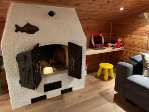 a living room with a fireplace in a house at Alpendomizil Apfel in Mühlbach am Hochkönig