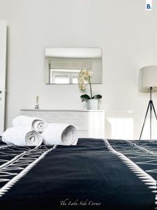a bedroom with a black and white bed and a mirror at [The LaKe-SiDe CorNer] Apartment in Como