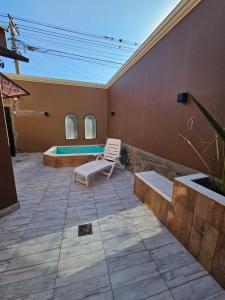 a patio with a chair and a swimming pool at Catalina Apart in San Salvador de Jujuy