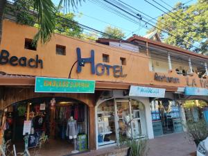 a store front of a store with a sign on it at Hotel La Palapa in Tamarindo