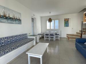 a living room with a couch and a table at Villa Pont d'En Gil in Cala en Blanes