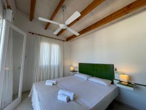 a bedroom with a bed with two towels on it at Villa Pont d'En Gil in Cala en Blanes +12 photos