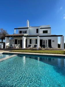 a house with a swimming pool in front of a house at Villa Pont d'En Gil in Cala en Blanes