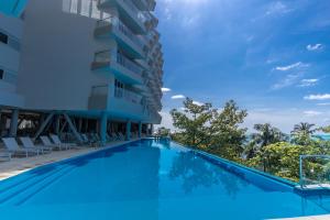 a large swimming pool next to a building at Grand Sirenis San Andres in San Andrés
