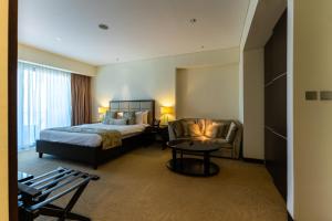 a hotel room with a bed and a chair at Spacious, Modern Studio in Marina Dubai in Dubai