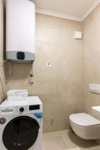 a bathroom with a washing machine and a toilet at ADRIATIC VIEW M in Bar