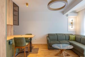 a living room with a couch and a table at ADRIATIC VIEW M in Bar