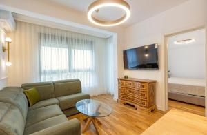 a living room with a couch and a tv and a bed at ADRIATIC VIEW M in Bar