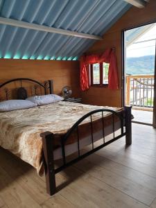 a bedroom with a large bed in a room at HOSTAL MACONDO in Manizales