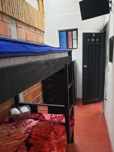 a room with a bunk bed and a door at HOSTAL MACONDO in Manizales