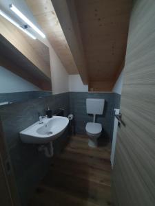 a bathroom with a sink and a toilet at La ciöda Malenca in Cave dʼArdesia