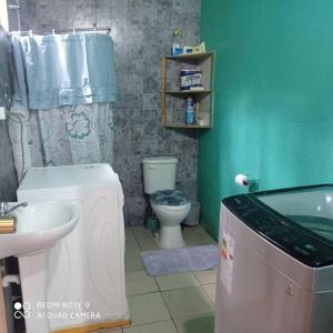 a bathroom with a sink and a toilet and a tub at Cabañas Don Esteban in Tortel