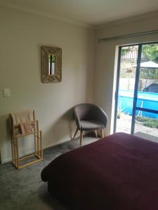 a bedroom with a bed and a chair and a mirror at Cozy Double Room - WIFI in Hamilton
