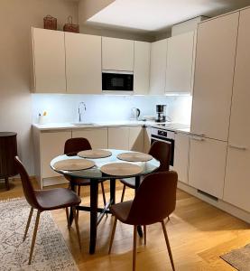 a kitchen with a table and chairs in it at Modern apartment in a prime location in Helsinki