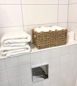 two baskets of towels on a shelf in a bathroom at Modern apartment in a prime location in Helsinki