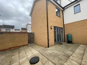 an empty patio in front of a brick building at Family & Business Stays In RG2 - Sleeps Up to 12! in Reading
