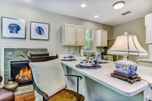 a kitchen with a table and a fireplace at 5422 Leonard Street in Fernandina Beach