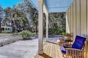 a porch with two chairs and a table at 5422 Leonard Street in Fernandina Beach
