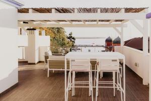 a white table and chairs on a balcony at Apartamentos Sol & Ria in Olhão