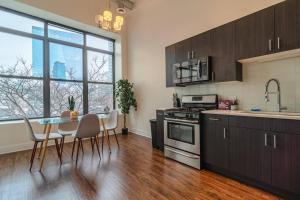 a kitchen with a table and a dining room at McCormick Place 420 friendly 3BR/2BA with optional Parking for up to 8 guests in Chicago