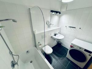 a bathroom with a tub and a sink and a toilet at PREMIUM SKI IN/OUT - STEINADLER in Obertauern