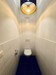 a bathroom with a toilet and a light at PREMIUM SKI IN/OUT - STEINADLER in Obertauern