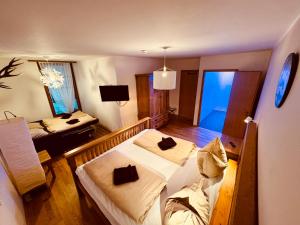 a small room with two beds and a television at PREMIUM SKI IN/OUT - STEINADLER in Obertauern