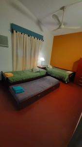 Una cama o camas en una habitación de La Manquel - Casa y Yungas