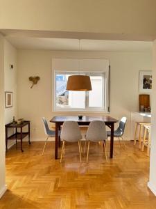 a dining room with a table and chairs and a window at Porto Lidador Boutique Ap with Garden - Alvaro in Porto
