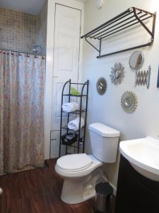 a bathroom with a toilet and a sink and a shower at Studio SoCo in Austin