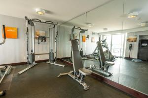 a gym with tread machines and a mirror at Comfort Inn & Conference Centre Toronto Airport in Toronto