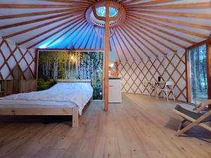 a bedroom with a bed in a yurt at Jurta Na Skraju Lasu in Zawady