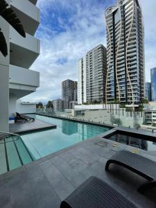 a large swimming pool with buildings in the background at Views and Vibes - Free Parking - great location! in Brisbane