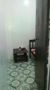 a corner of a room with a table and a floor at 4jMarte Home Stay in Imus