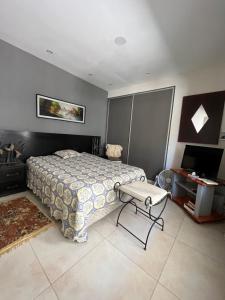 a bedroom with a bed and a table in it at Bonita Pampa in Santa Rosa