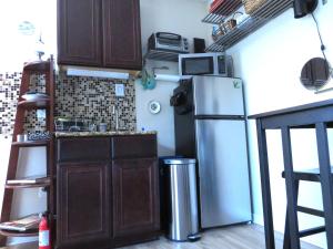 a kitchen with a refrigerator and a microwave at Studio SoCo in Austin