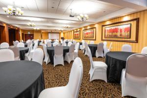 a conference room with black tables and white chairs at Comfort Inn & Conference Centre Toronto Airport in Toronto