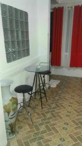 a room with a table and two stools in it at 4jMarte Home Stay in Imus