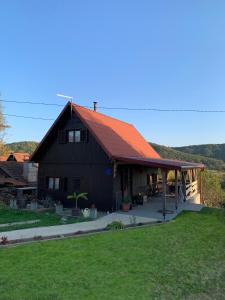 a large black house with an orange roof at Holiday home with hot tube, near the river in Pokupsko +24 photos
