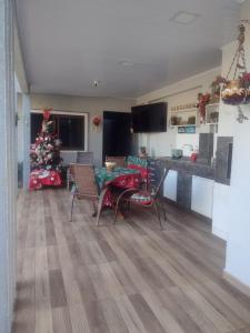 a living room with a table and a christmas tree at Cantinho da Sônia in Foz do Iguaçu