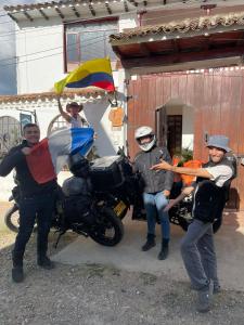 a group of people standing next to a motorcycle at Family Host HOSTEL in Villa de Leyva
