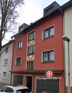 a red building with a car parked in front of it at Apartment R41 in Essen