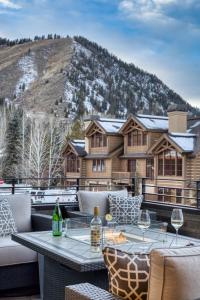 a patio with a table and chairs in front of a mountain at Luxe Sun Valley Retreat at River Run in Ketchum