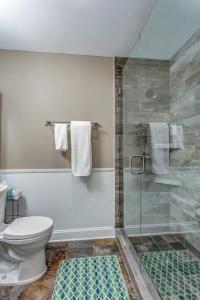 a bathroom with a toilet and a glass shower at Nashville Downtown Condo -788 in Nashville