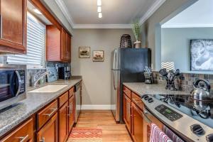 a kitchen with a sink and a refrigerator at Nashville Downtown Condo -788 in Nashville